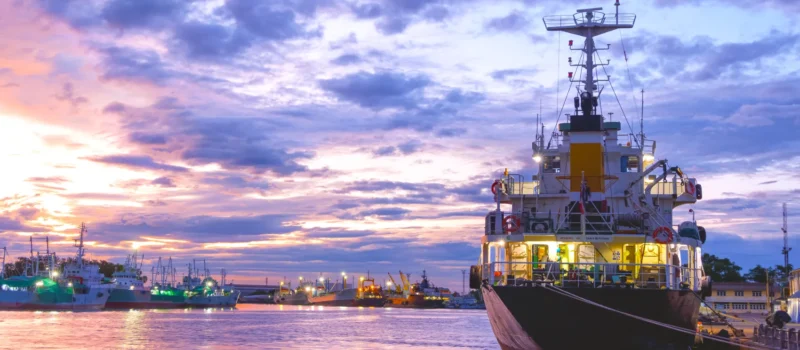 Oil tanker ship with nautical vessels.